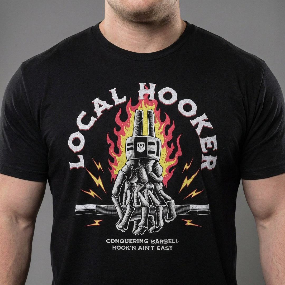 Local Hooker tee in Black: a skeleton hand locked in a hook grip on a barbell in front of roaring flames and lightning