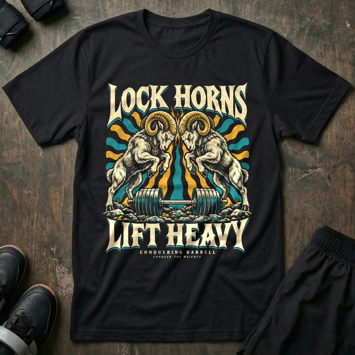 Lock Horns Lift Heavy - Tee front graphic in Black with two bighorn rams locking horns over a loaded barbell - Conquering Barbell