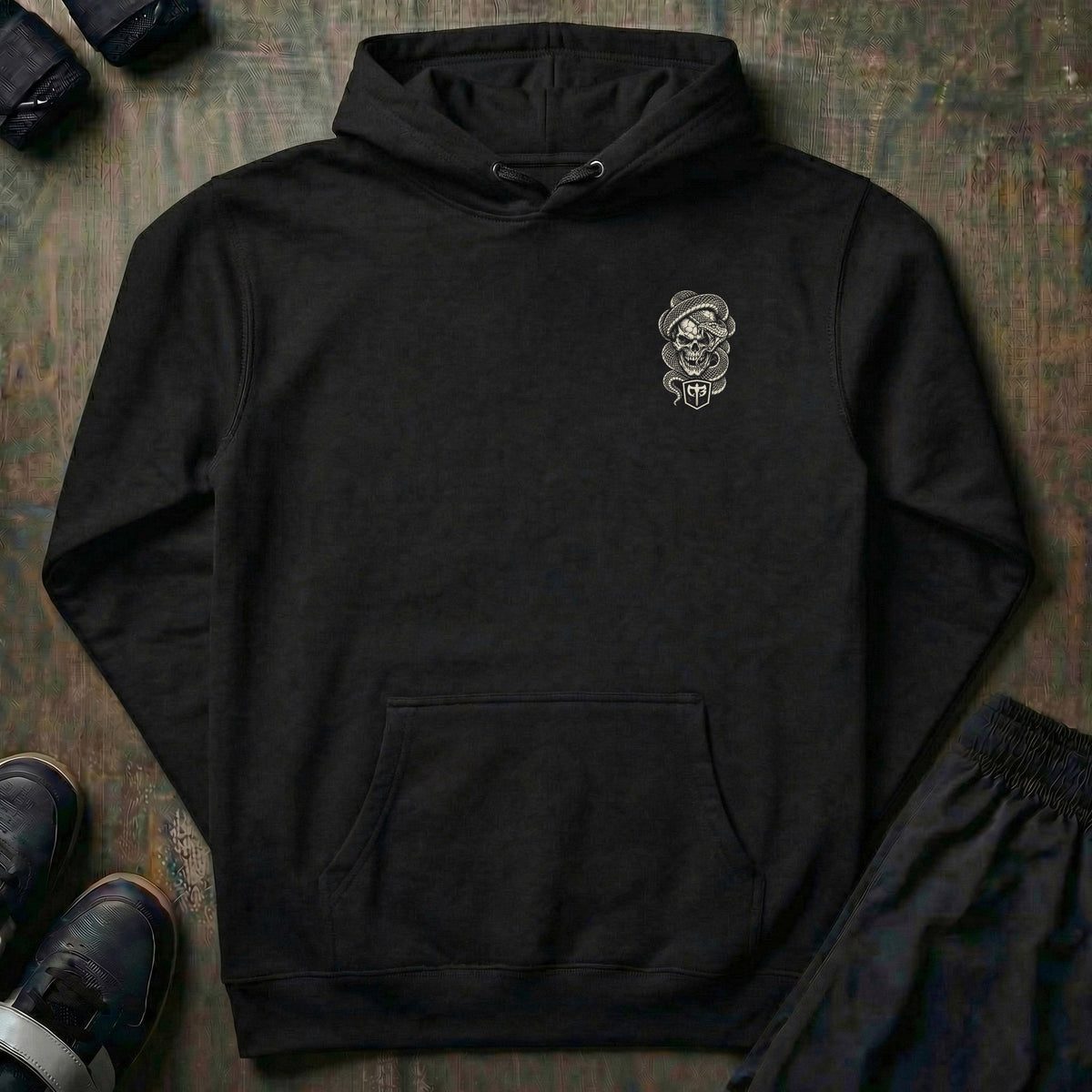 Lockjaw pullover hoodie in Black: a skull wrapped in a striking snake