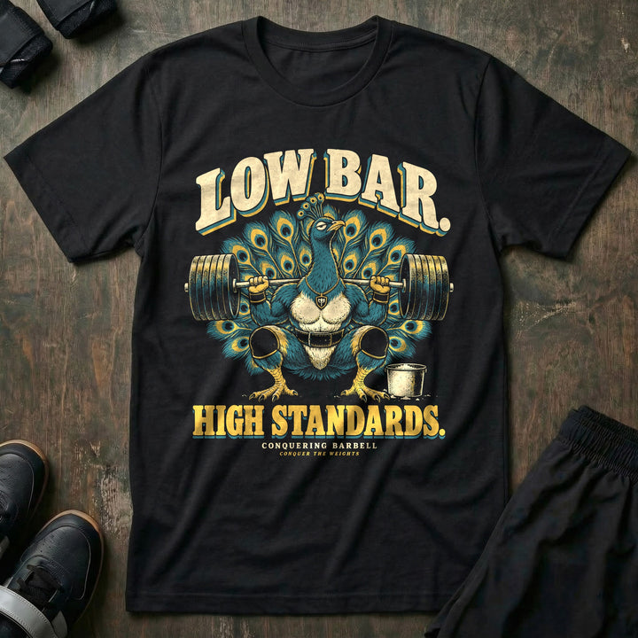 Low Bar High Standards - Tee front graphic in Black with a peacock with its tail fanned out in a low-bar squat - Conquering Barbell