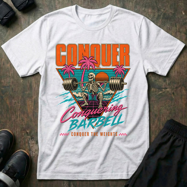Miami Gains tee in White: a skeleton squatting a loaded barbell inside a retro sunset triangle with pink palm trees