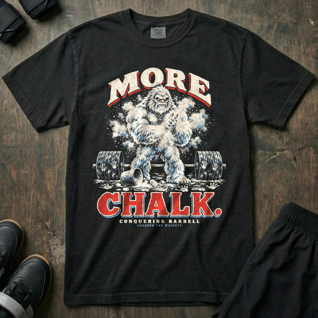 More Chalk - Relaxed Fit Tee front graphic in Black with a yeti clapping a cloud of chalk over a loaded barbell covered in handprints - Conquering Barbell