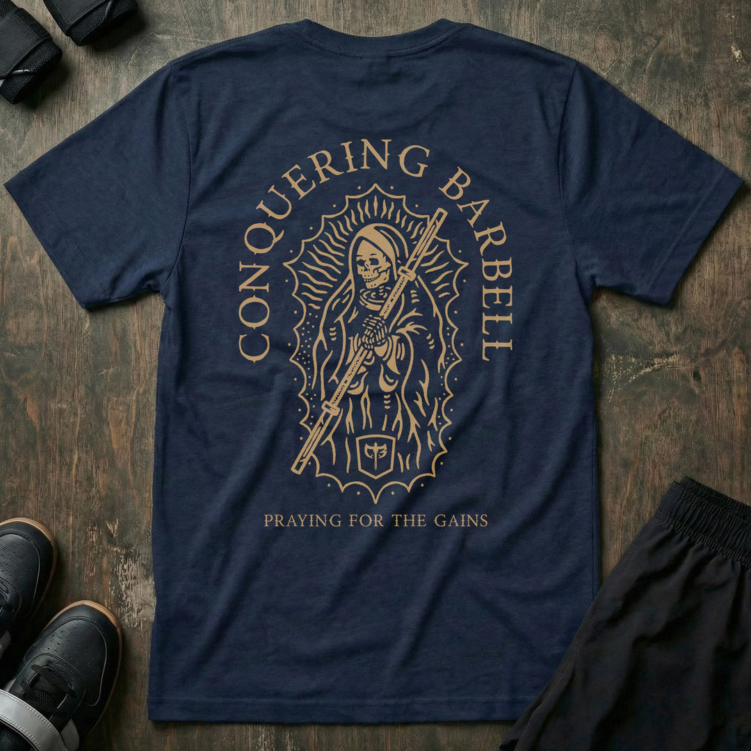 Mother of Iron tee in Navy: a skeletal saint draped in robes clutching a barbell sleeve inside an ornate halo frame