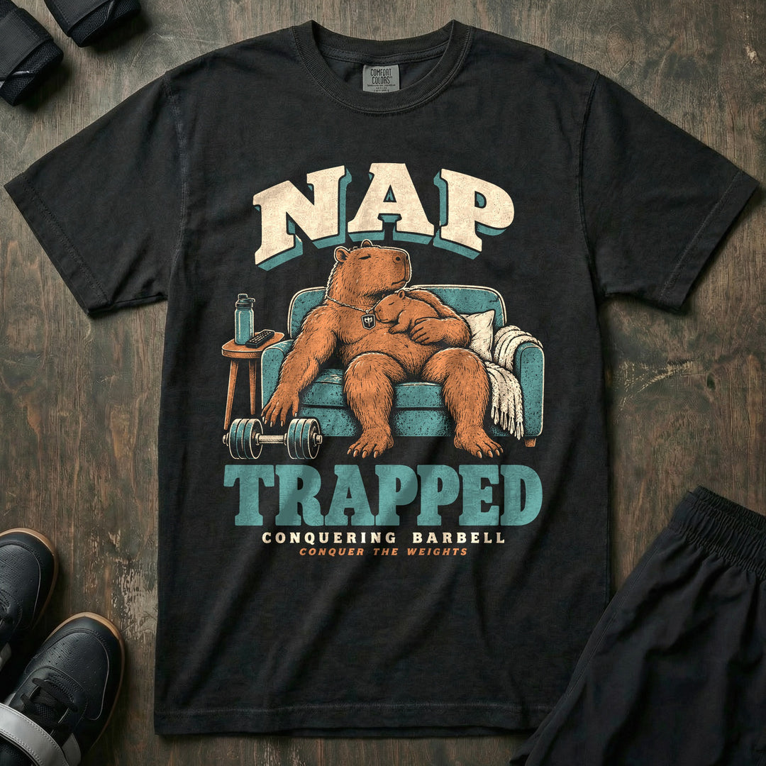 Nap Trapped - Relaxed Fit Tee front graphic in Black with a capybara dad asleep in an armchair with a baby capybara sleeping on his chest and a dumbbell on the floor - Conquering Barbell