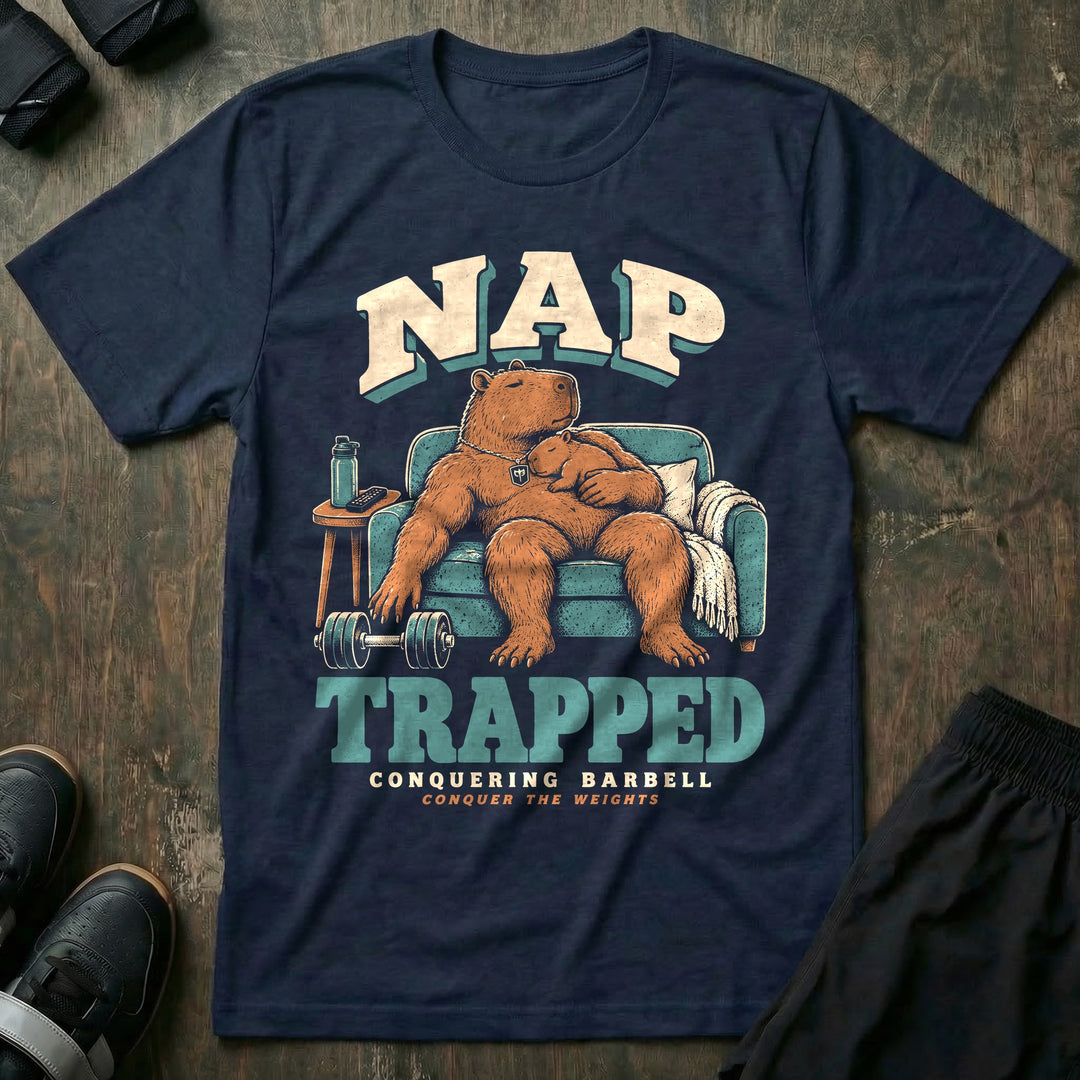 Nap Trapped - Tee front graphic in Navy with a capybara dad asleep in an armchair with a baby capybara sleeping on his chest and a dumbbell on the floor - Conquering Barbell