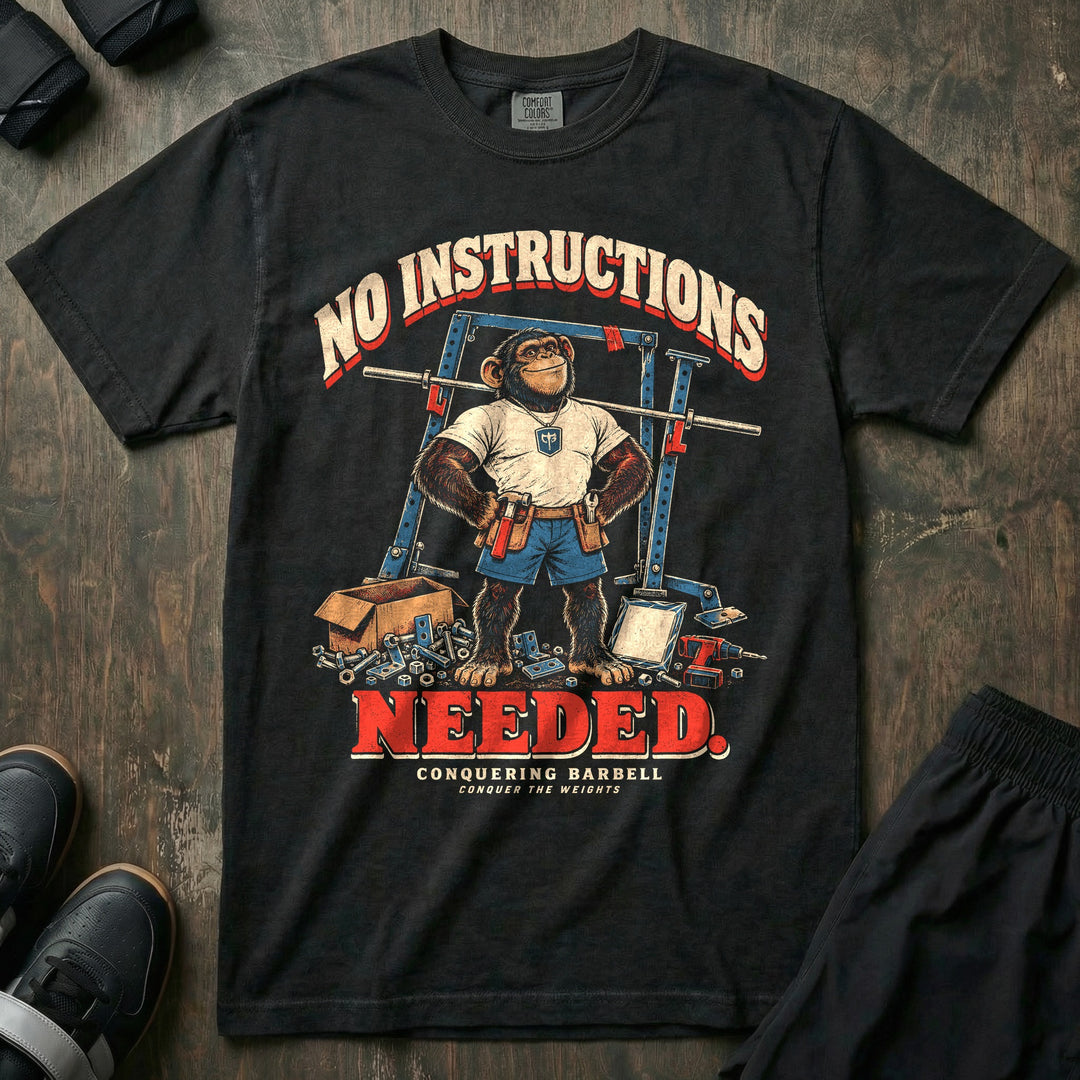 No Instructions Needed - Relaxed Fit Tee front graphic in Black with a chimp dad in a tool belt standing in front of a crooked power rack with spare bolts on the floor - Conquering Barbell