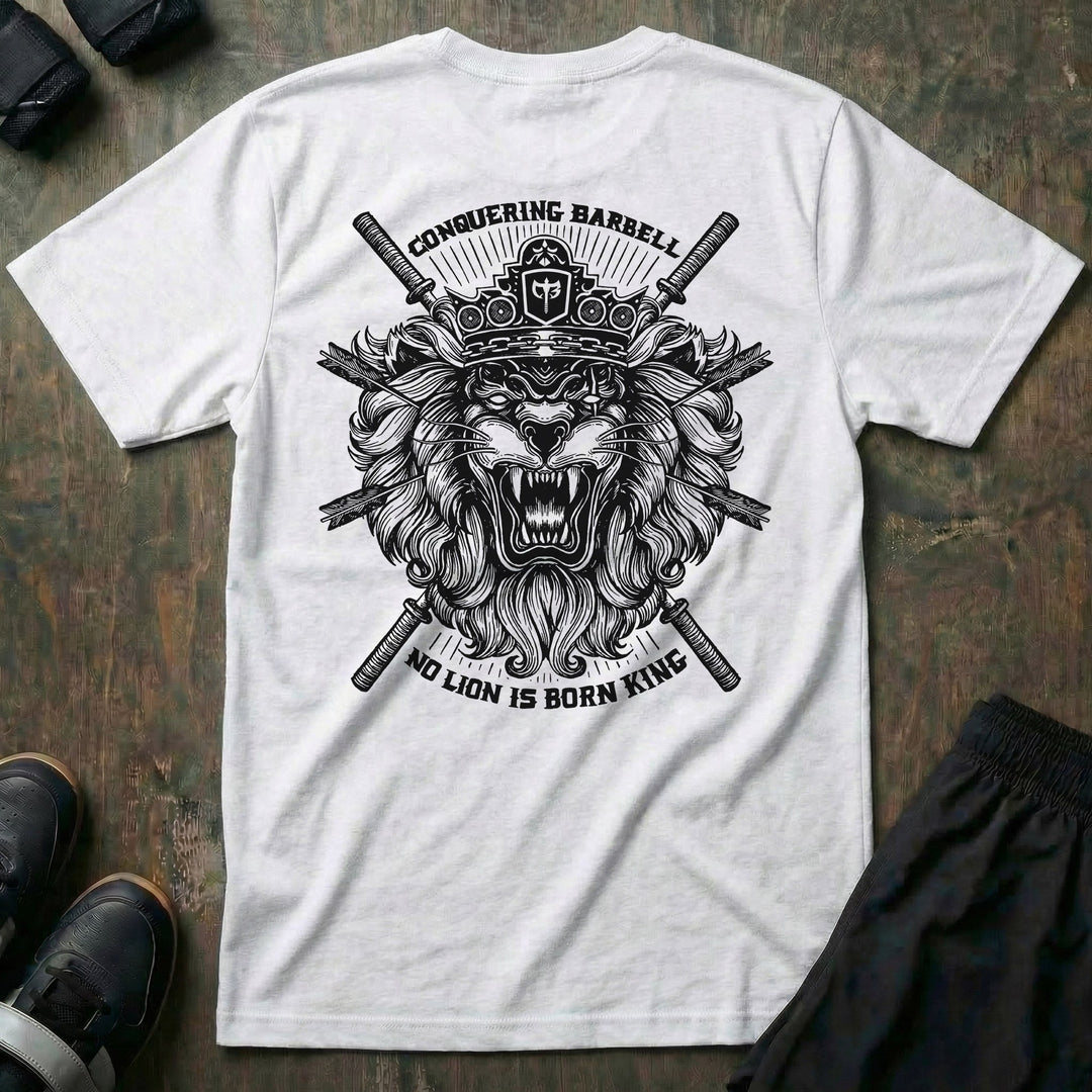 No Lion is Born King tee in White: a roaring lion in front of crossed barbells