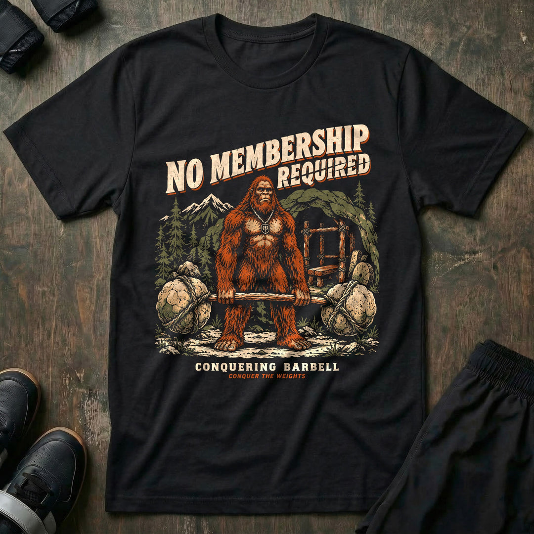 No Membership Required - Tee front graphic in Black with a sasquatch deadlifting a log loaded with boulders in the forest - Conquering Barbell