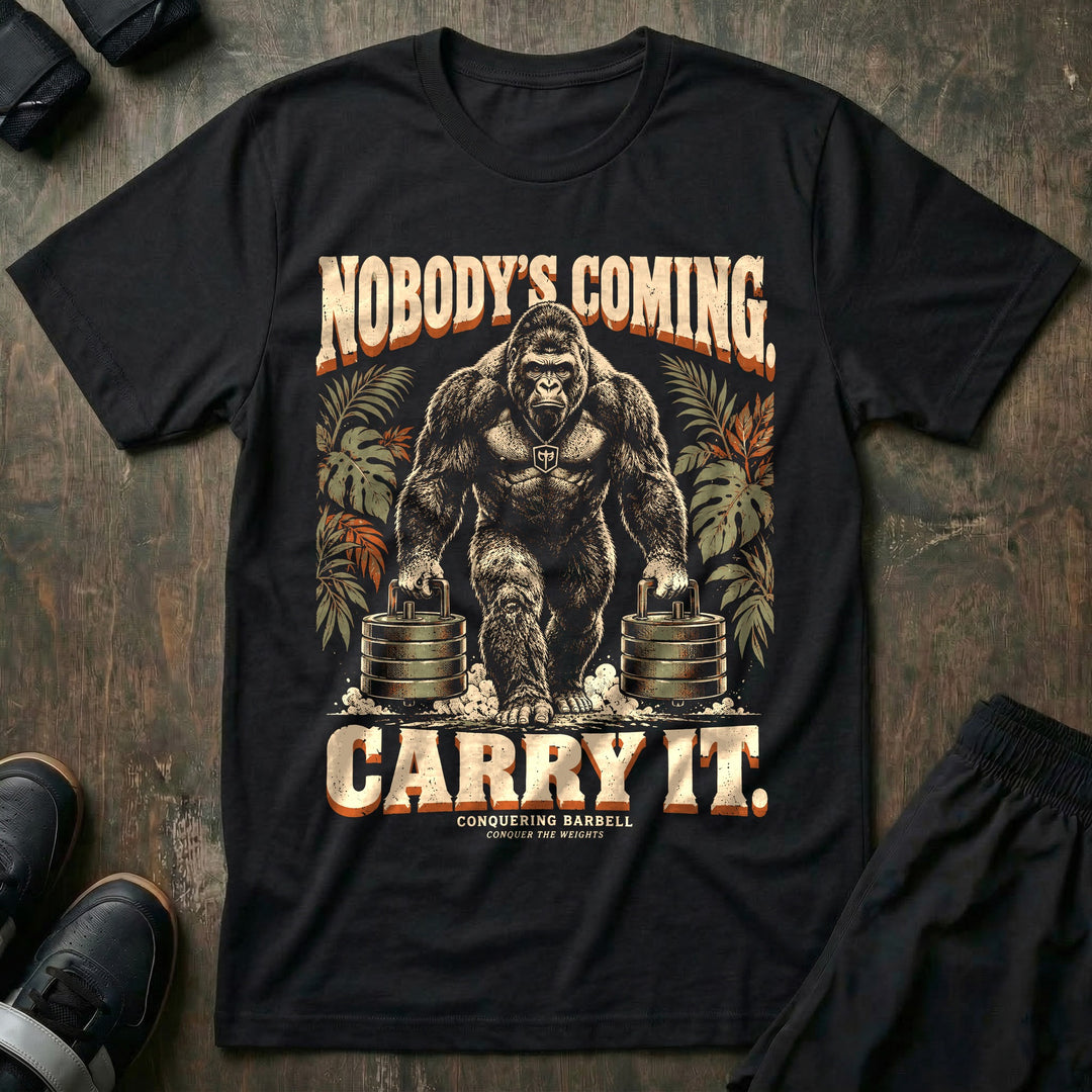 Nobody's Coming Carry It - Tee front graphic in Black with a silverback gorilla farmer's carrying a stack of weight plates in each hand - Conquering Barbell