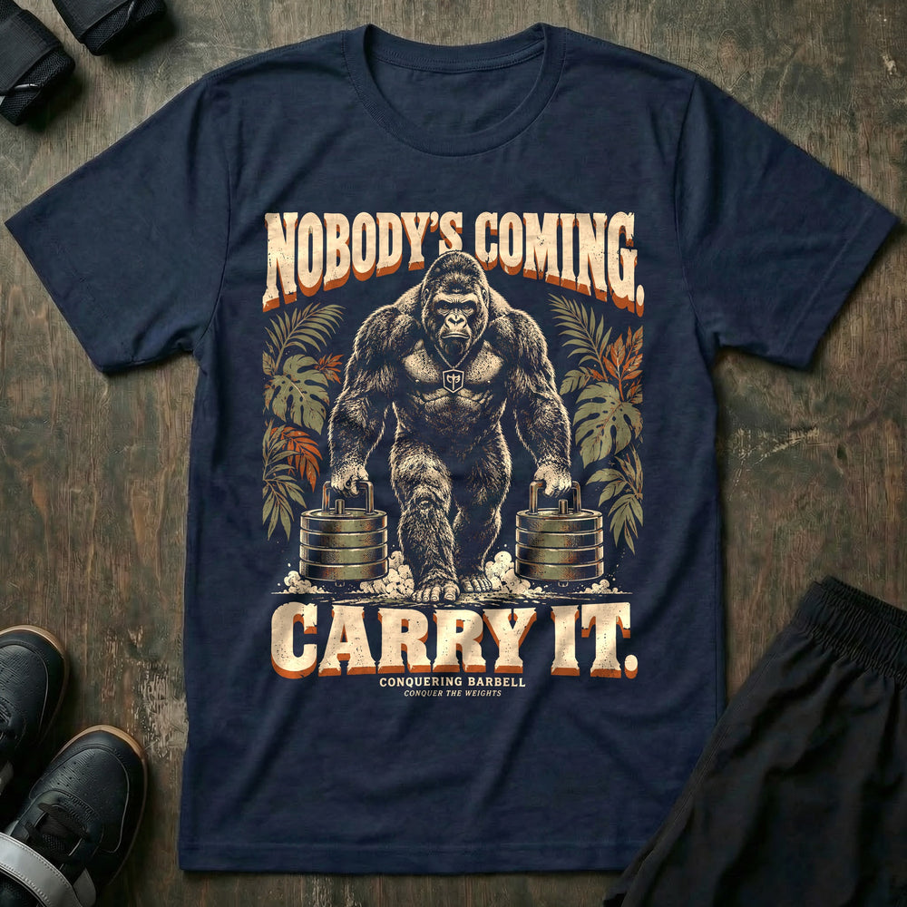 Nobody's Coming Carry It - Tee front graphic in Navy with a silverback gorilla farmer's carrying a stack of weight plates in each hand - Conquering Barbell