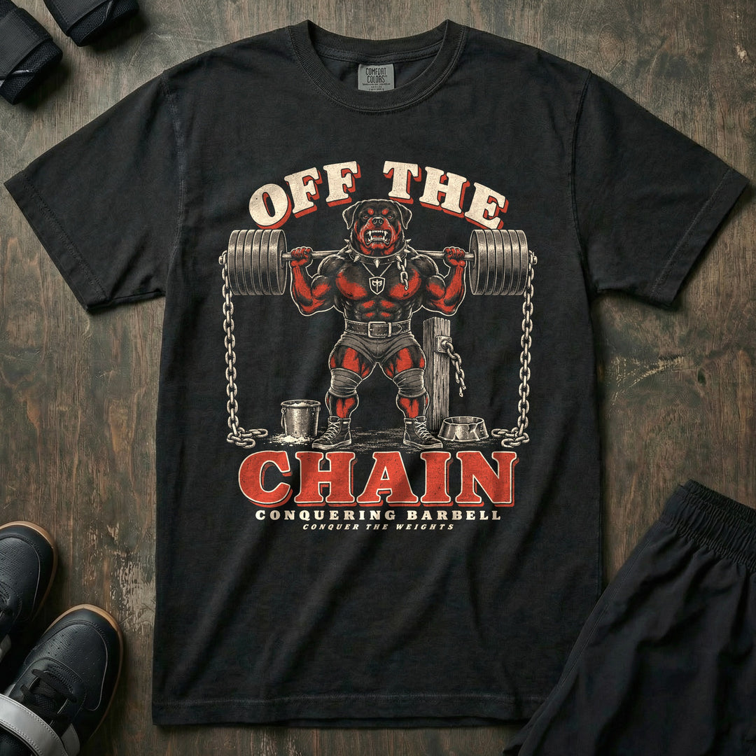 Off the Chain - Relaxed Fit Tee front graphic in Black with a snarling Rottweiler squatting a loaded barbell hung with chains beside a broken chain post - Conquering Barbell