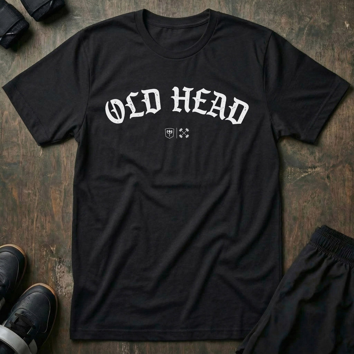 Old Head tee in Black: OLD HEAD in bold old English lettering arched across the chest with small CB marks below