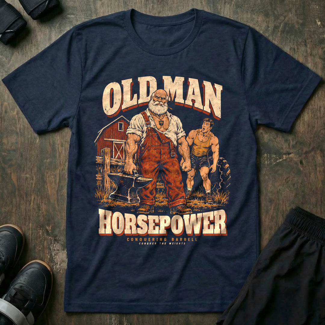 Old Man Horsepower - Tee front graphic in Navy with a white-bearded farmer in overalls carrying an anvil in one hand while a young lifter strains at a tractor tire - Conquering Barbell