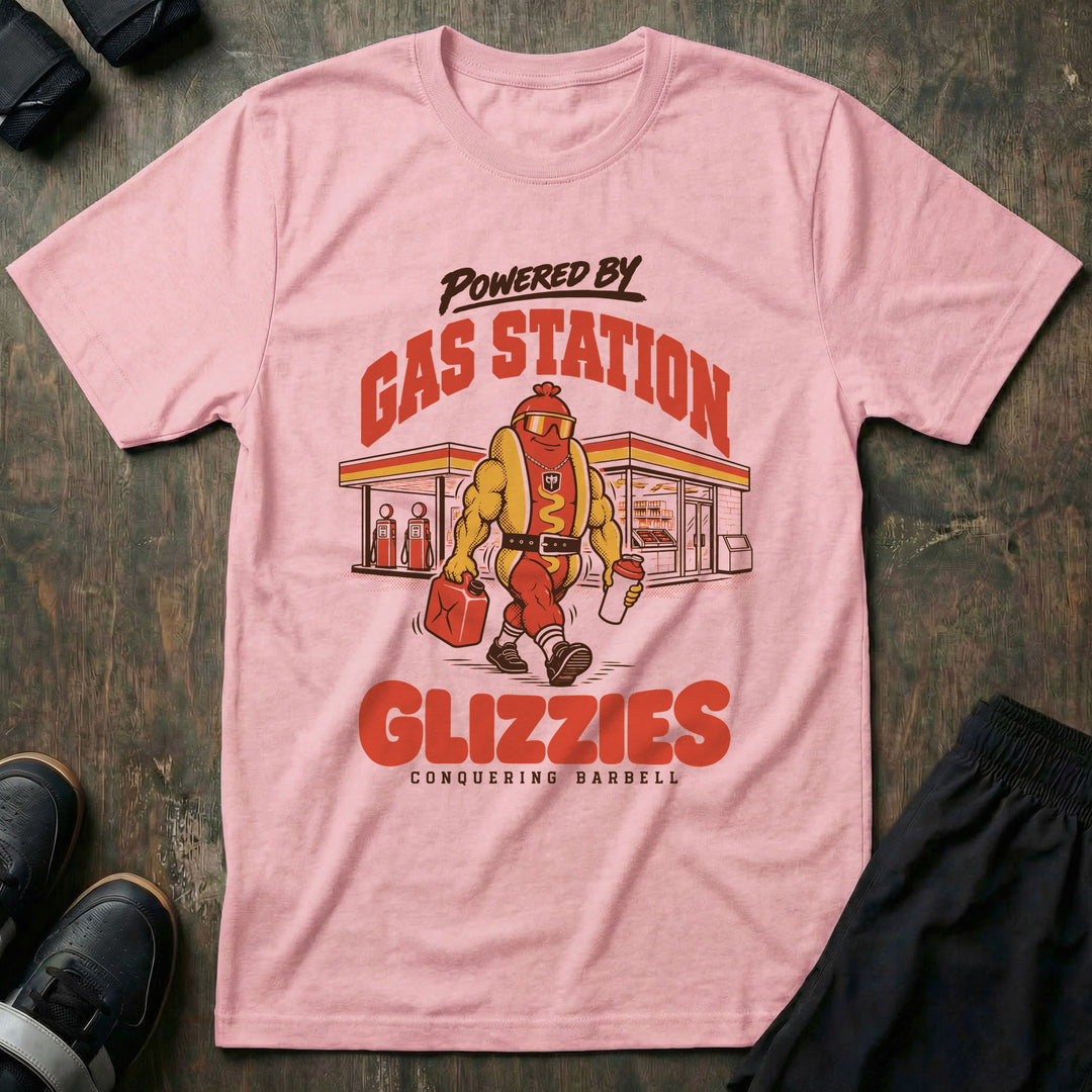 Powered by Gas Station Glizzies - Tee front graphic in Pink with a muscular hot dog lifter walking out of a gas station under POWERED BY GAS STATION GLIZZIES - Conquering Barbell