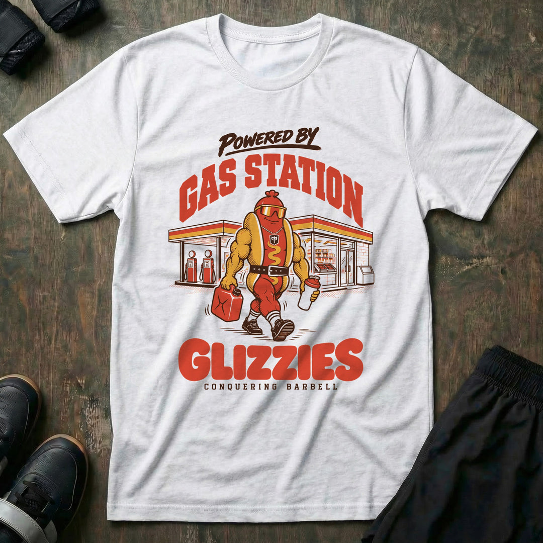 Powered by Gas Station Glizzies - Tee front graphic in White with a muscular hot dog lifter walking out of a gas station under POWERED BY GAS STATION GLIZZIES - Conquering Barbell