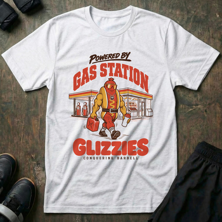 Powered by Gas Station Glizzies - Tee front graphic in White with a muscular hot dog lifter walking out of a gas station under POWERED BY GAS STATION GLIZZIES - Conquering Barbell
