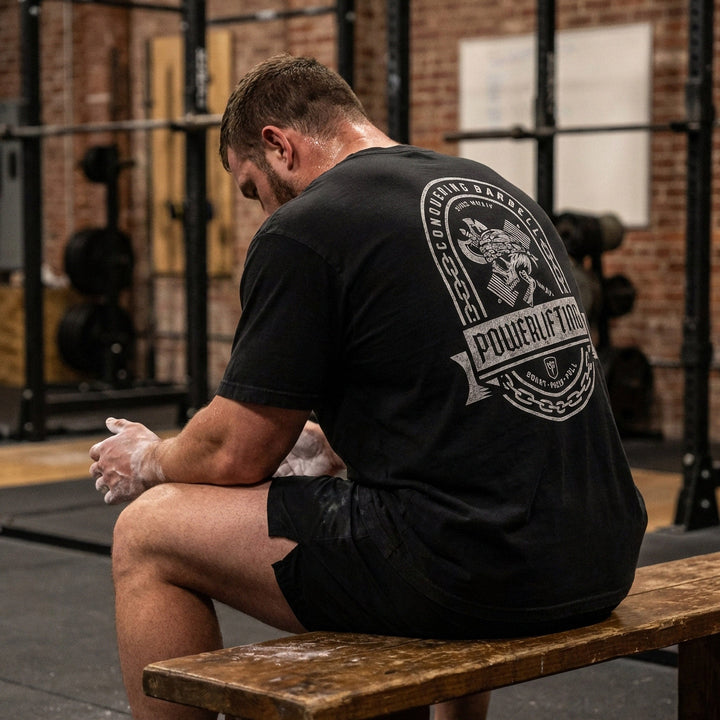 Powerlifting Badge relaxed fit tee in Black: a distressed emblem with chain border