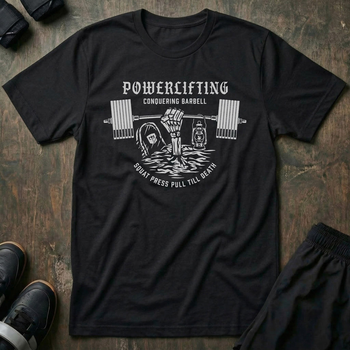 Powerlifting Till Death tee in Black: a skeleton hand rising from the depths to grip a loaded barbell