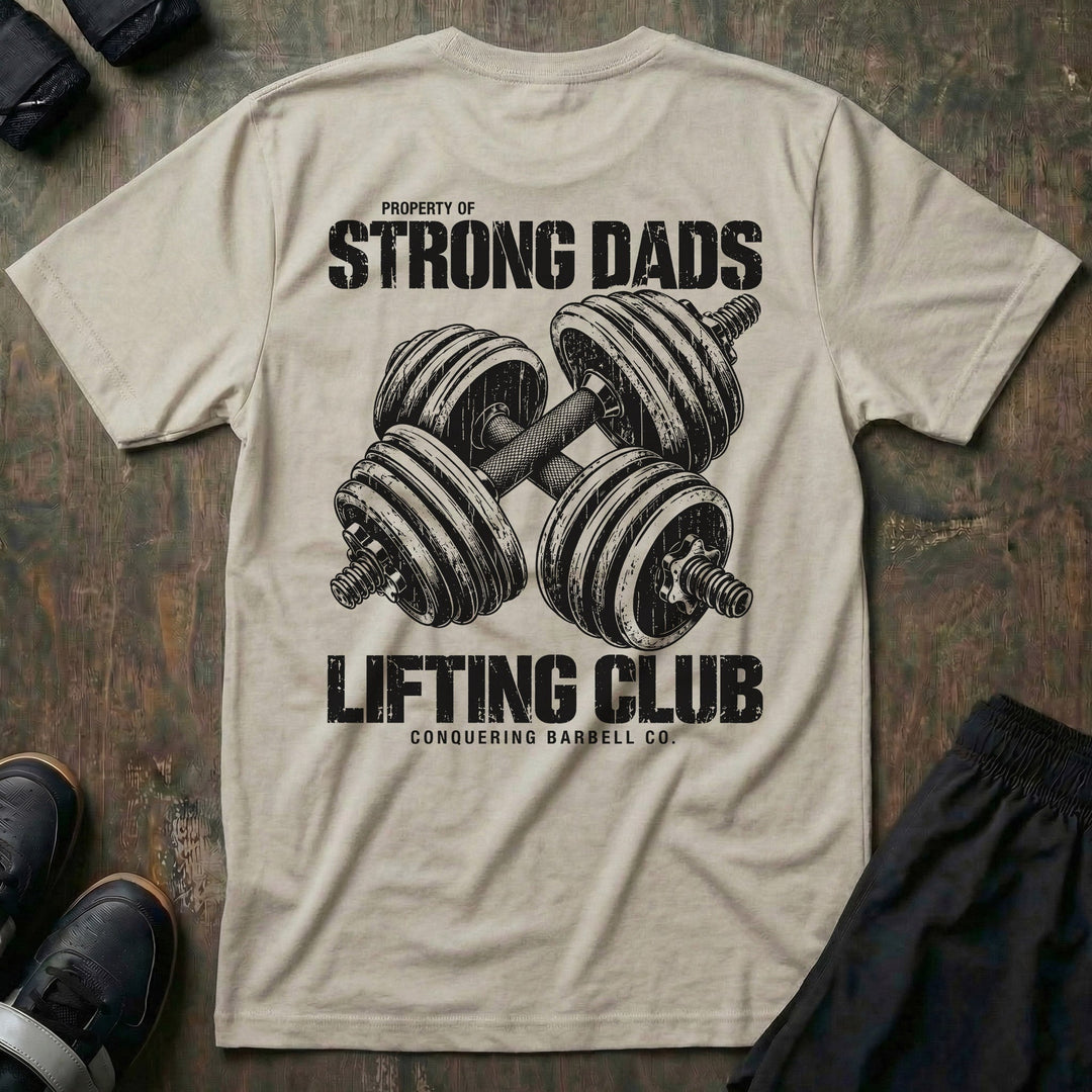 Property of Strong Dads Lifting Club tee in Sand: a pair of crossed dumbbells between PROPERTY OF STRONG DADS