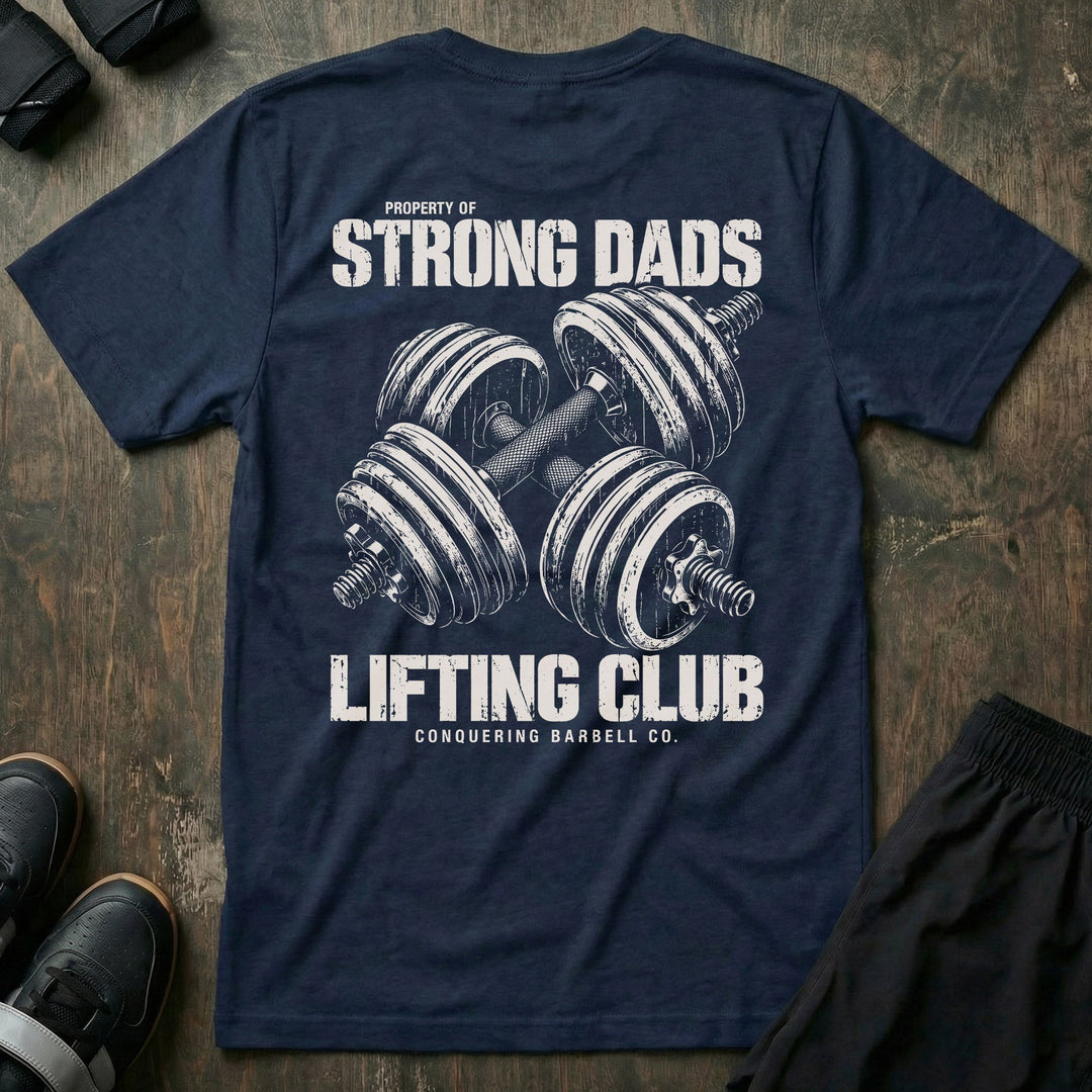 Property of Strong Dads Lifting Club tee in Navy: a pair of crossed dumbbells between PROPERTY OF STRONG DADS