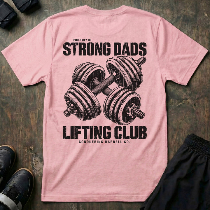Property of Strong Dads Lifting Club tee in Pink: a pair of crossed dumbbells between PROPERTY OF STRONG DADS