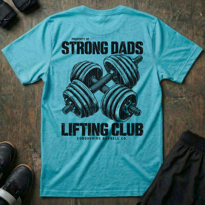 Property of Strong Dads Lifting Club tee in Tahiti: a pair of crossed dumbbells between PROPERTY OF STRONG DADS