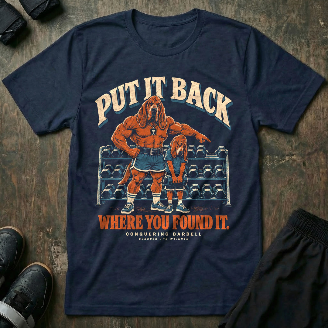 Put It Back Where You Found It - Tee front graphic in Navy with a bloodhound dad pointing at a dumbbell rack while a young bloodhound holds a dumbbell with his head down - Conquering Barbell