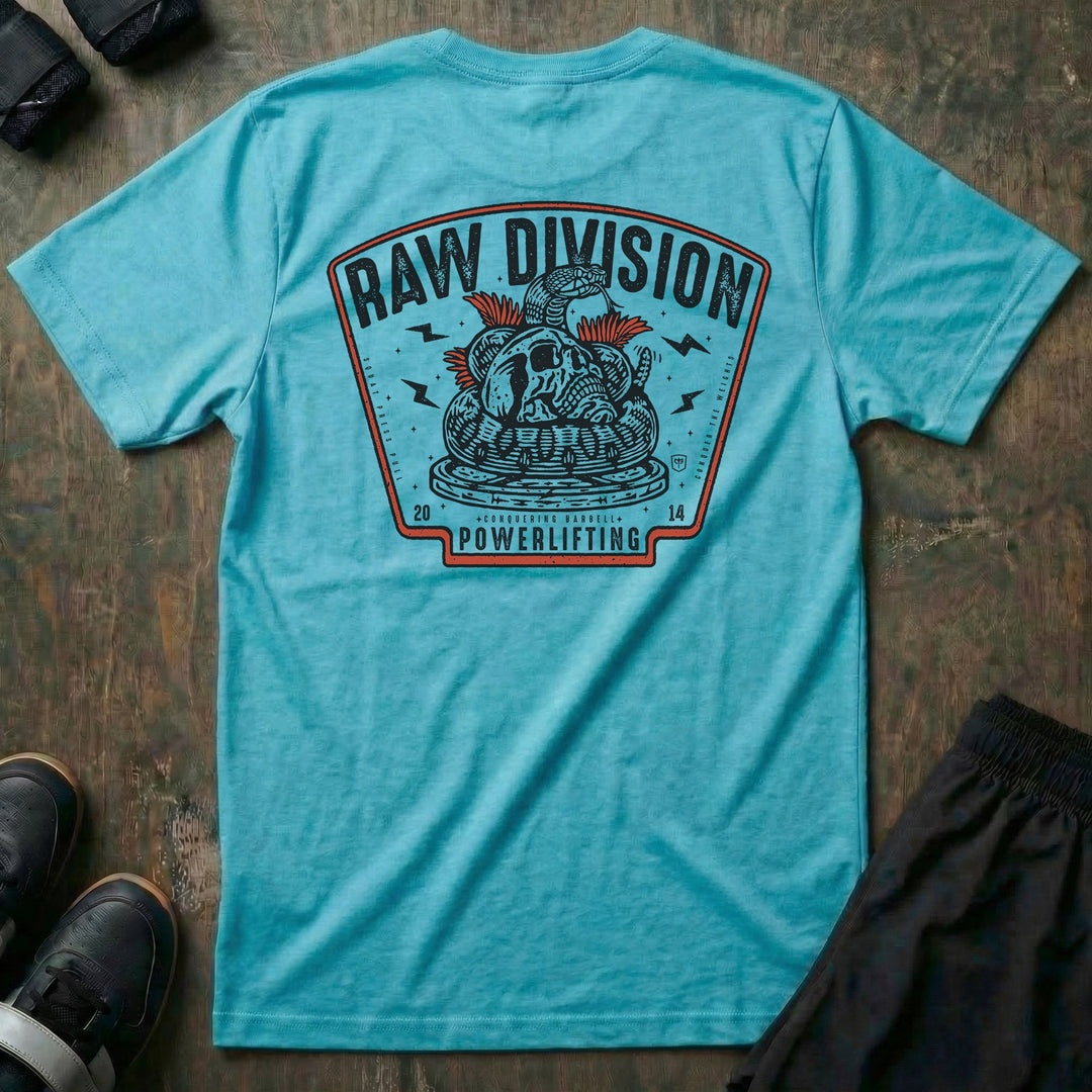 Raw Division tee in Tahiti: a coiled rattlesnake wrapped around a skull on a stack of weight plates inside a bold badge