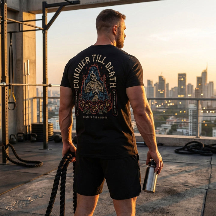 Reaper Rose tee in Black: a hooded reaper clutching a loaded barbell plate against a backdrop of flames