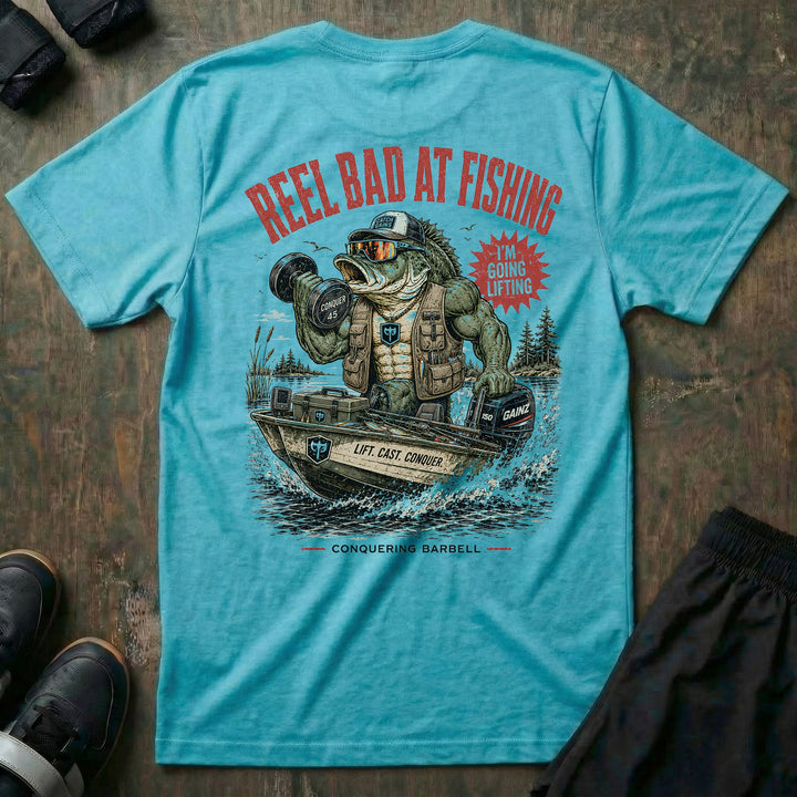Reel Bad at Fishing tee in Tahiti: a jacked gator in a cap and vest cruising in a fishing boat with a dumbbell in hand