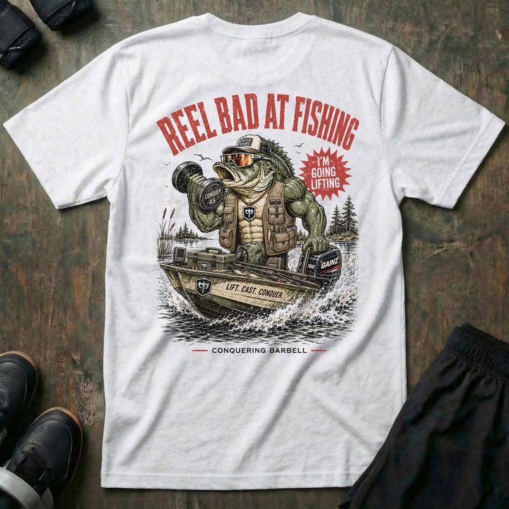Reel Bad at Fishing tee in White: a jacked gator in a cap and vest cruising in a fishing boat with a dumbbell in hand