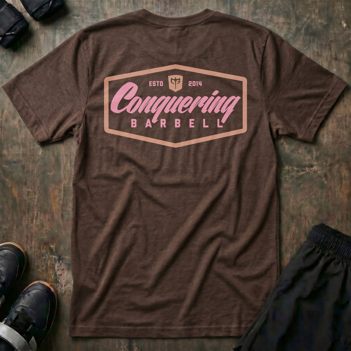 Script Logo Summer Vibes Edition tee in Expresso: the classic Conquering Barbell script logo inside a bold badge frame