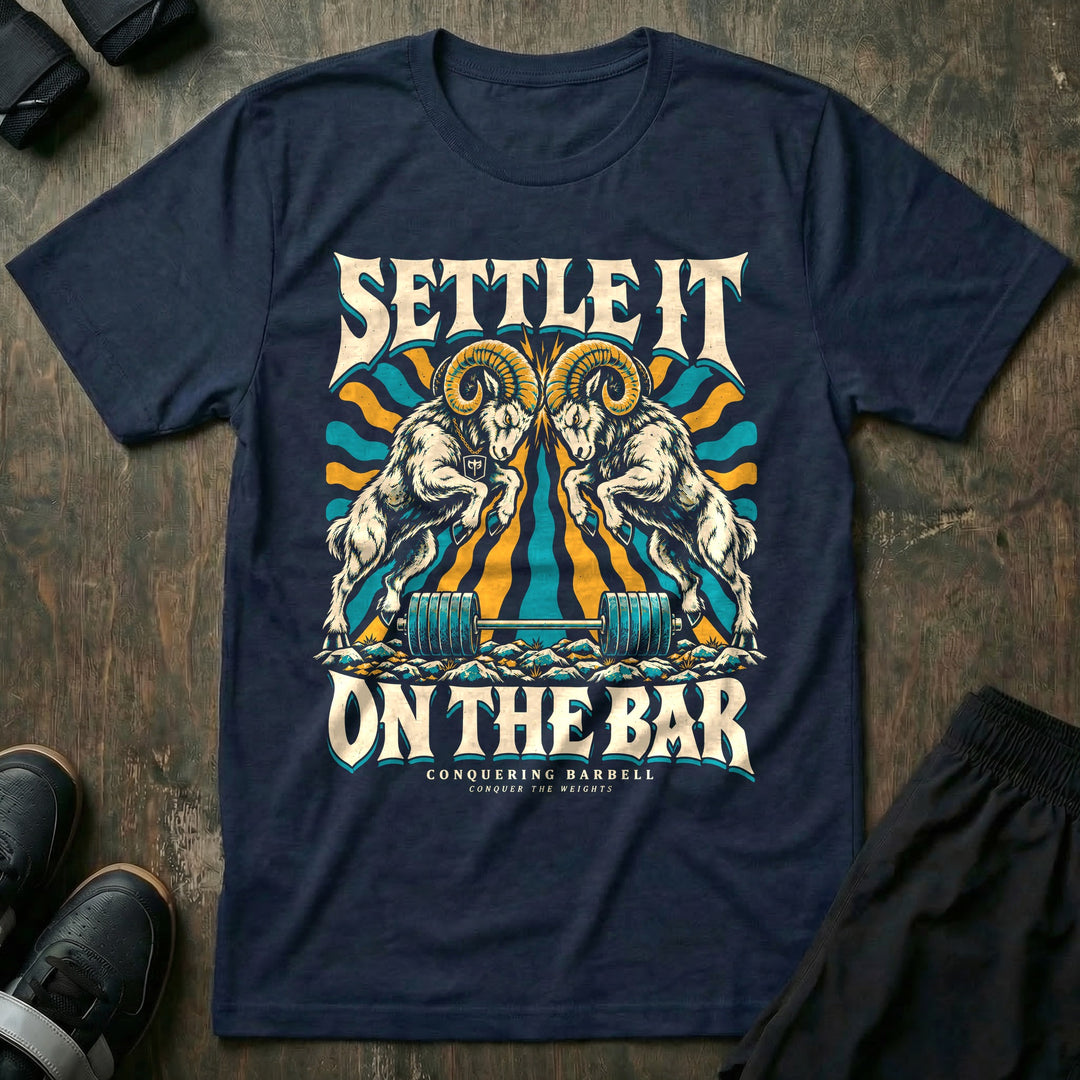 Settle It on the Bar - Tee front graphic in Navy with two bighorn rams locking horns over a loaded barbell - Conquering Barbell