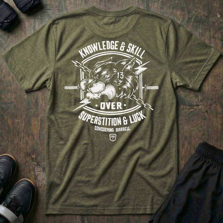 Skill Over Luck tee in Military: a snarling black cat marked with 13 flanked by crossed barbells and lightning bolts