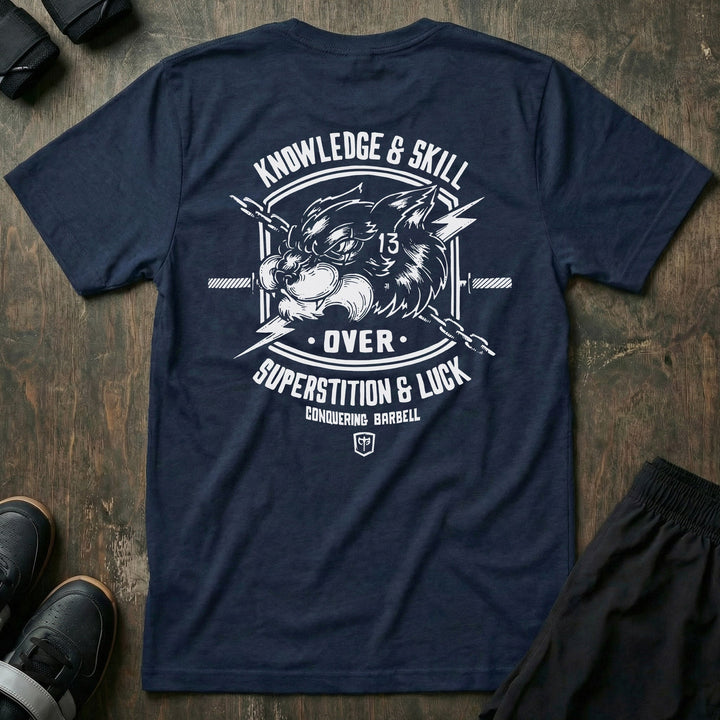 Skill Over Luck tee in Navy: a snarling black cat marked with 13 flanked by crossed barbells and lightning bolts