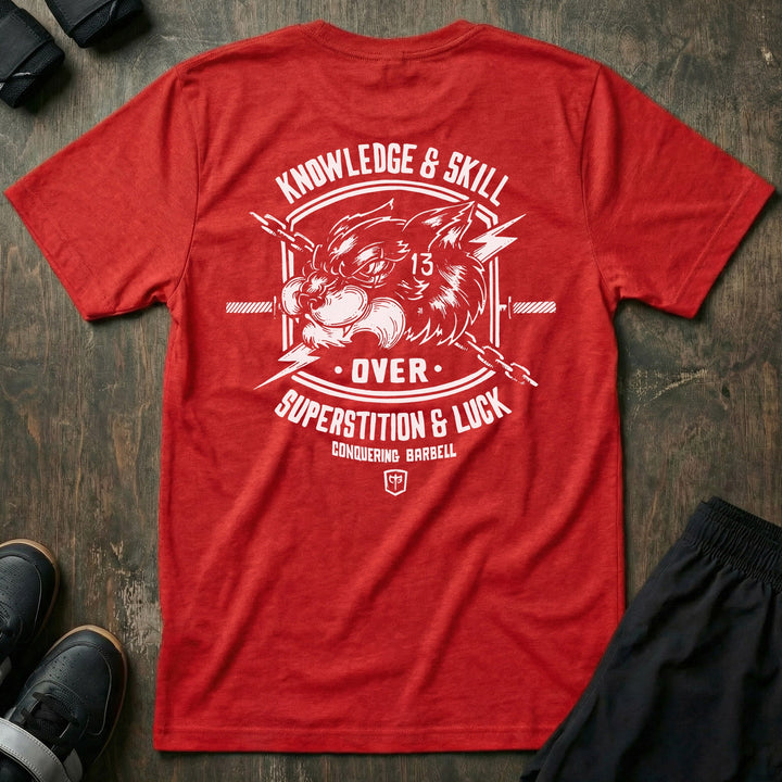 Skill Over Luck tee in Red: a snarling black cat marked with 13 flanked by crossed barbells and lightning bolts