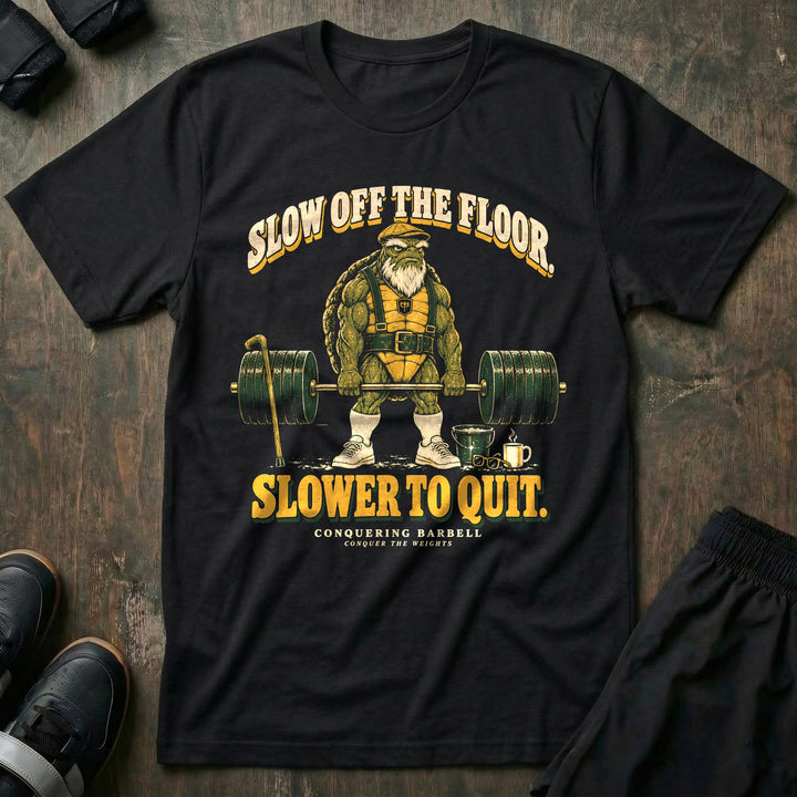 Slow Off the Floor Slower to Quit - Tee front graphic in Black with an old bearded tortoise in a flat cap at deadlift lockout - Conquering Barbell