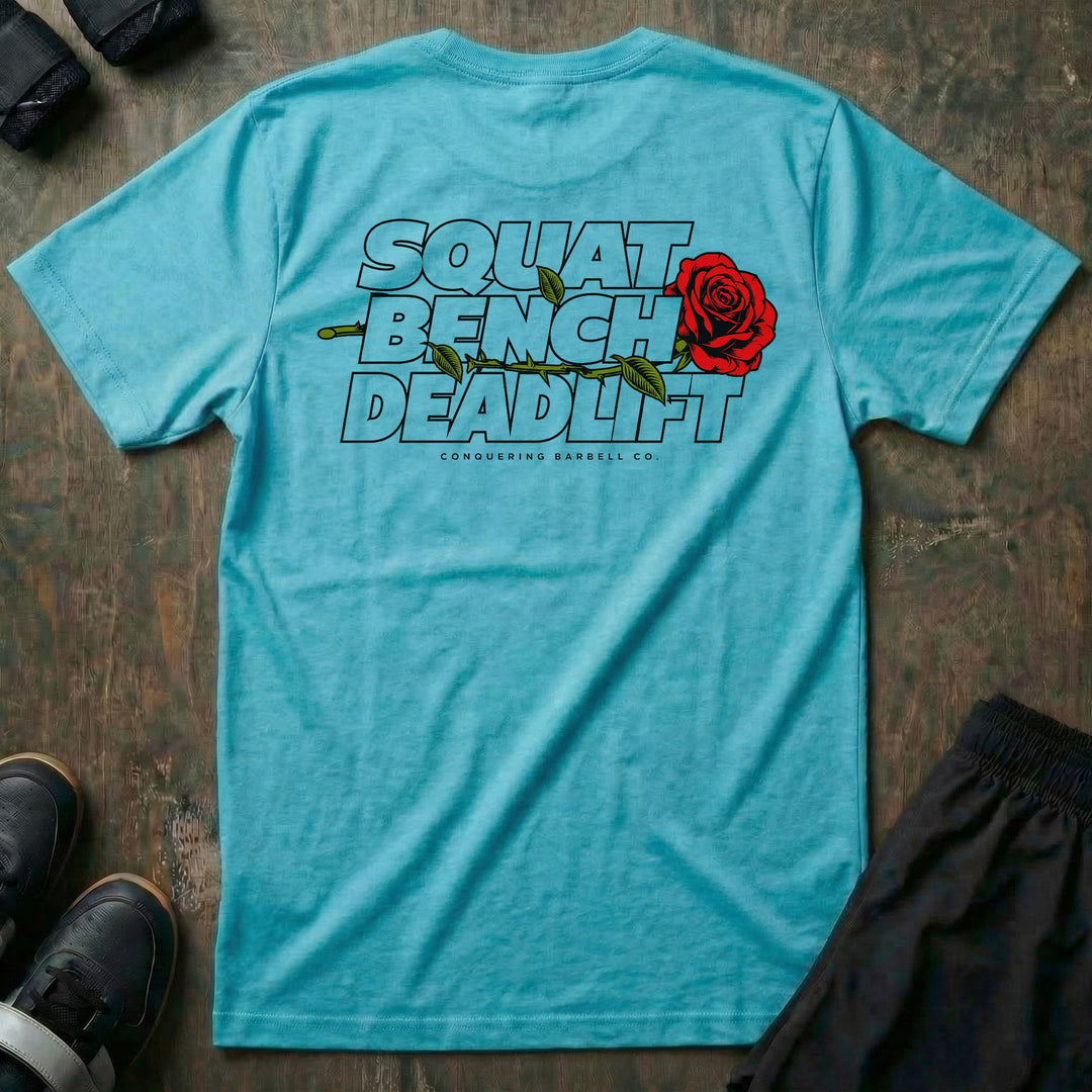 Squat Bench Deadlift Rose tee in Tahiti: SQUAT BENCH DEADLIFT stacked in bold outlined block lettering across the back