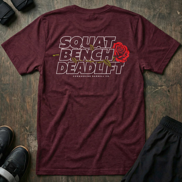 Squat Bench Deadlift Rose tee in Maroon: SQUAT BENCH DEADLIFT stacked in bold outlined block lettering across the back