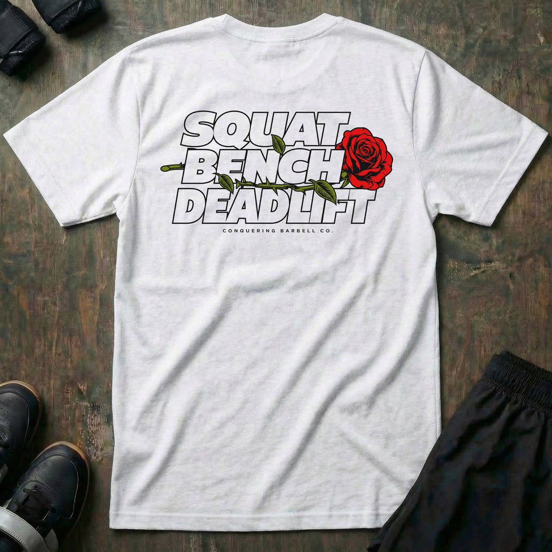 Squat Bench Deadlift Rose tee in White: SQUAT BENCH DEADLIFT stacked in bold outlined block lettering across the back