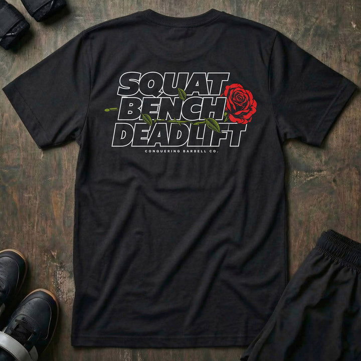 Squat Bench Deadlift Rose tee in Black: SQUAT BENCH DEADLIFT stacked in bold outlined block lettering across the back