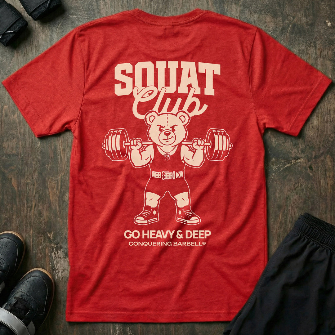 Squat Club tee in Red: a classic teddy bear squatting heavy in a lifting belt with a loaded barbell across his back