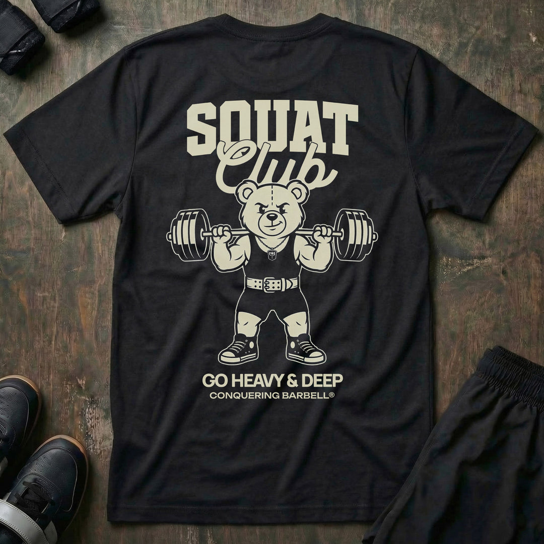 Squat Club tee in Black: a classic teddy bear squatting heavy in a lifting belt with a loaded barbell across his back