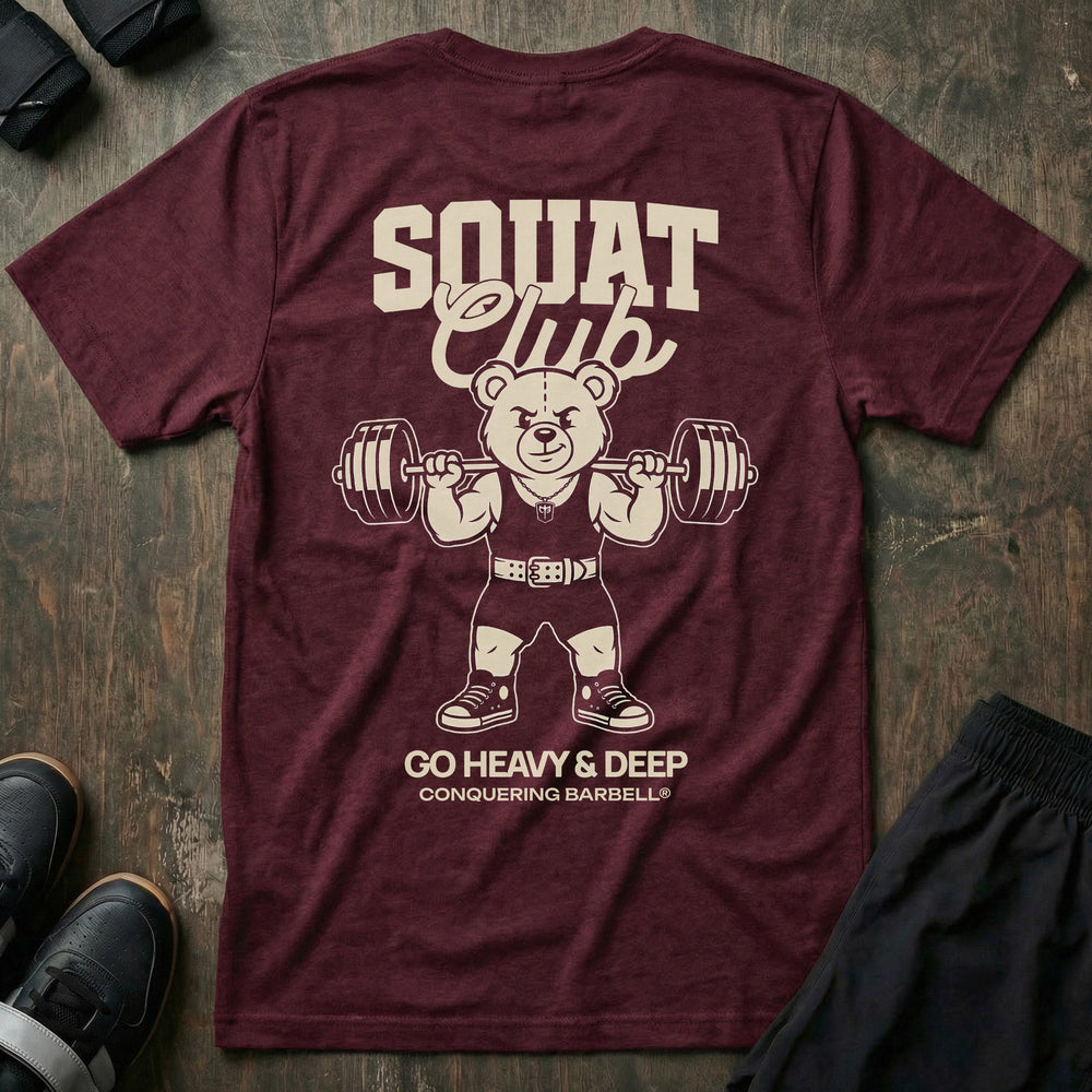 Squat Club tee in Maroon: a classic teddy bear squatting heavy in a lifting belt with a loaded barbell across his back