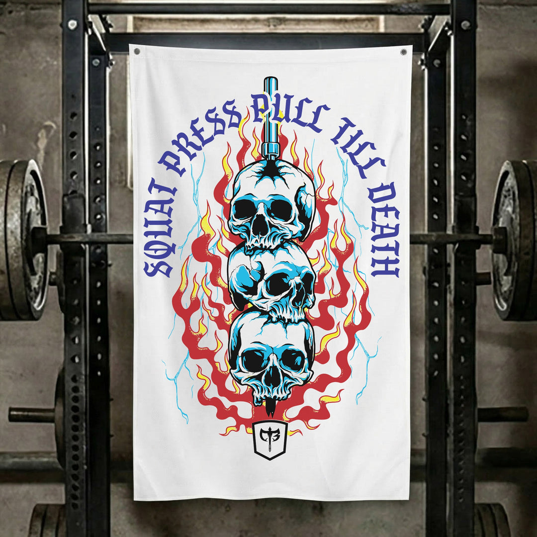 Squat Press Pull® Till Death-White - Polyester Flag, vertical white gym flag with three blue skulls stacked on a sword in red flames - Conquering Barbell