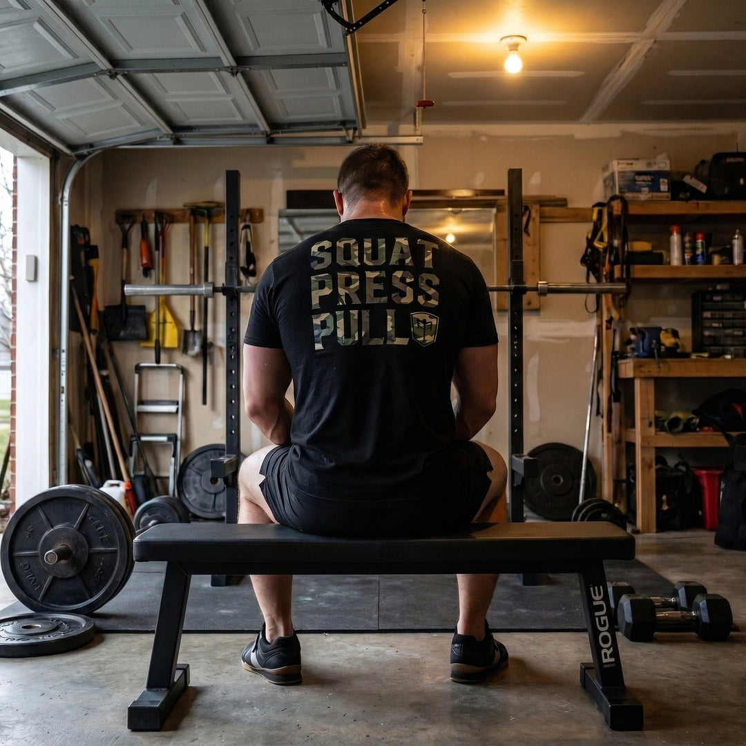 Squat Press Pull® tee in Black: SQUAT PRESS PULL in oversized woodland camo lettering stacked down the back