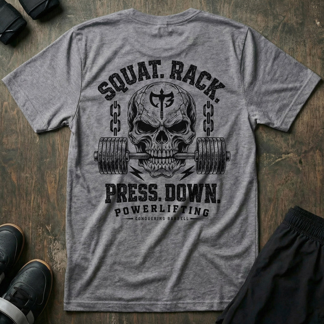 Squat. Rack. Press. Down. tee in Heather Grey: a skull with the CB shield biting down on a barbell between chains