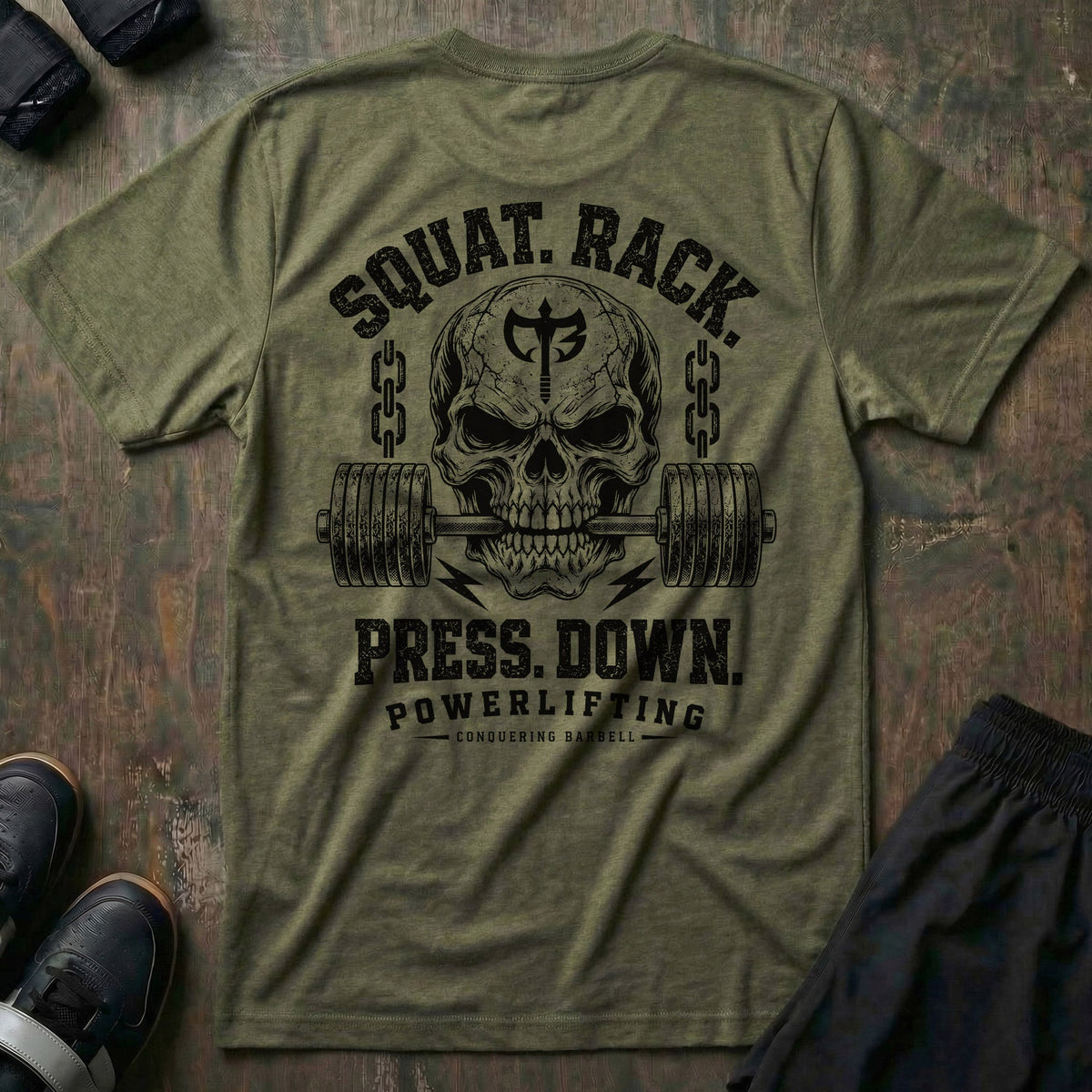 Squat. Rack. Press. Down. tee in Military: a skull with the CB shield biting down on a barbell between chains