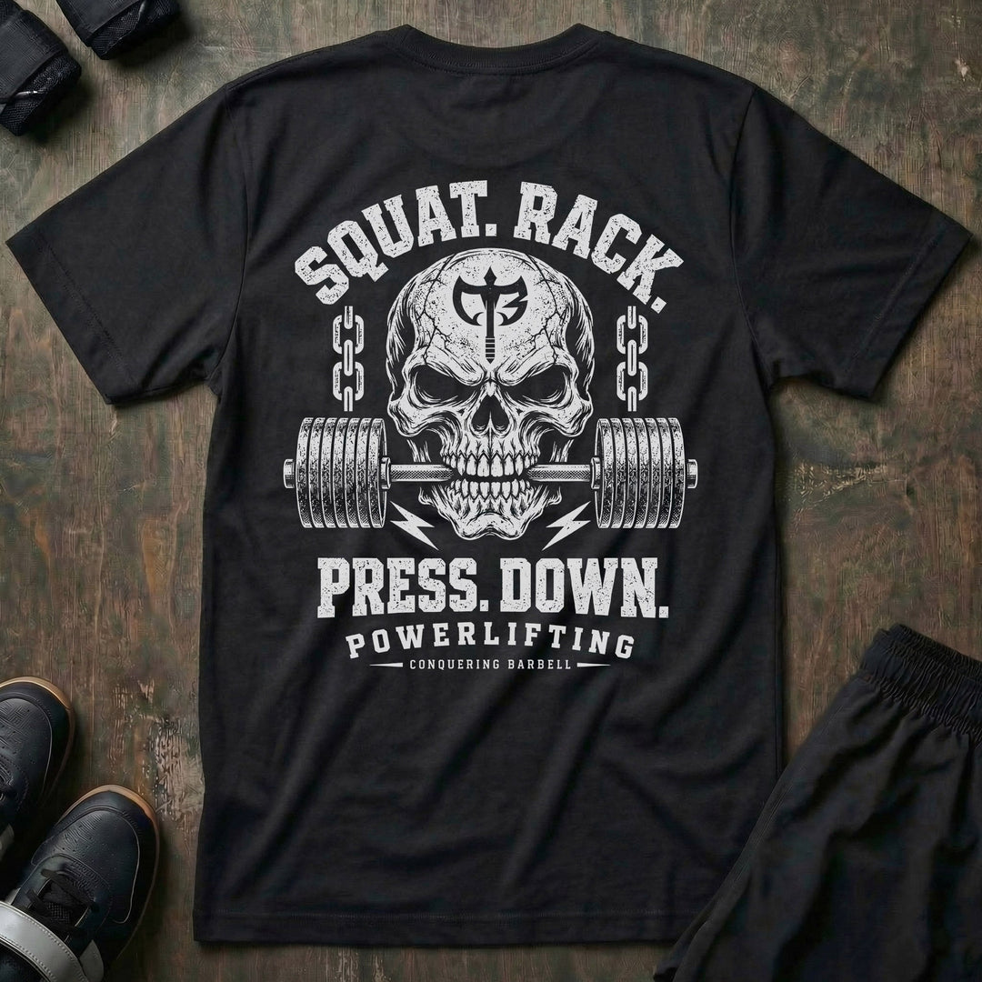Squat. Rack. Press. Down. tee in Black: a skull with the CB shield biting down on a barbell between chains
