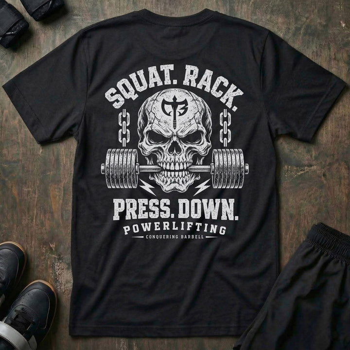 Squat. Rack. Press. Down. tee in Black: a skull with the CB shield biting down on a barbell between chains